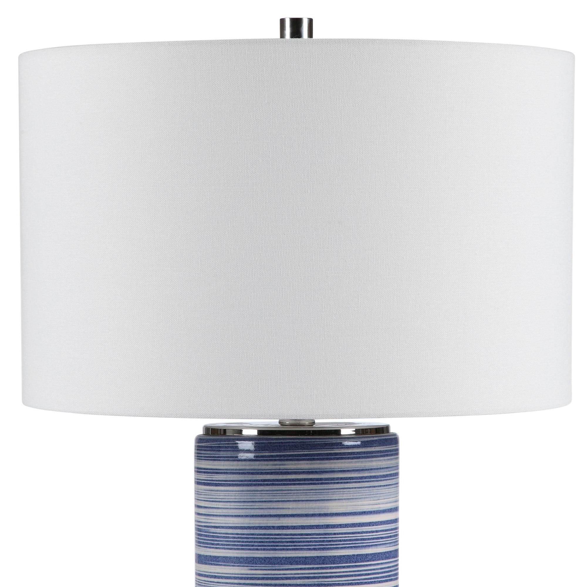 Shown in Showcasing Trendy White And Indigo Hues, This Ceramic Table Lamp Has A Striped Glaze With Polished N finish and Round Drum Hardback shade