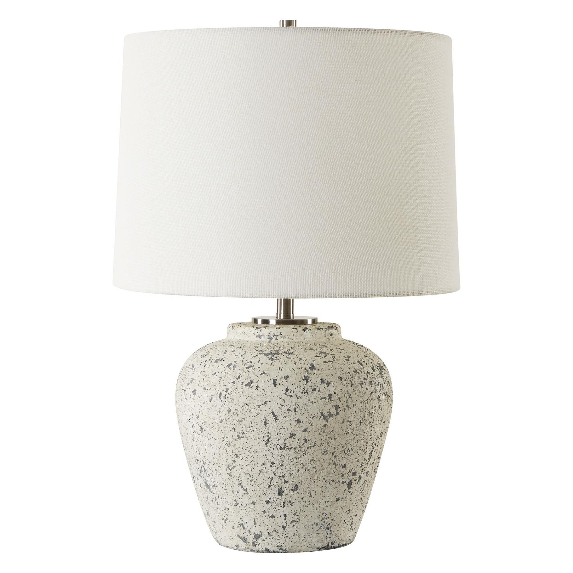 Shown in The Rupture Table Lamp Features A Heavily Distressed Aged Ivory Finish With Stone Gray Undertones An finish and Round Hardback shade