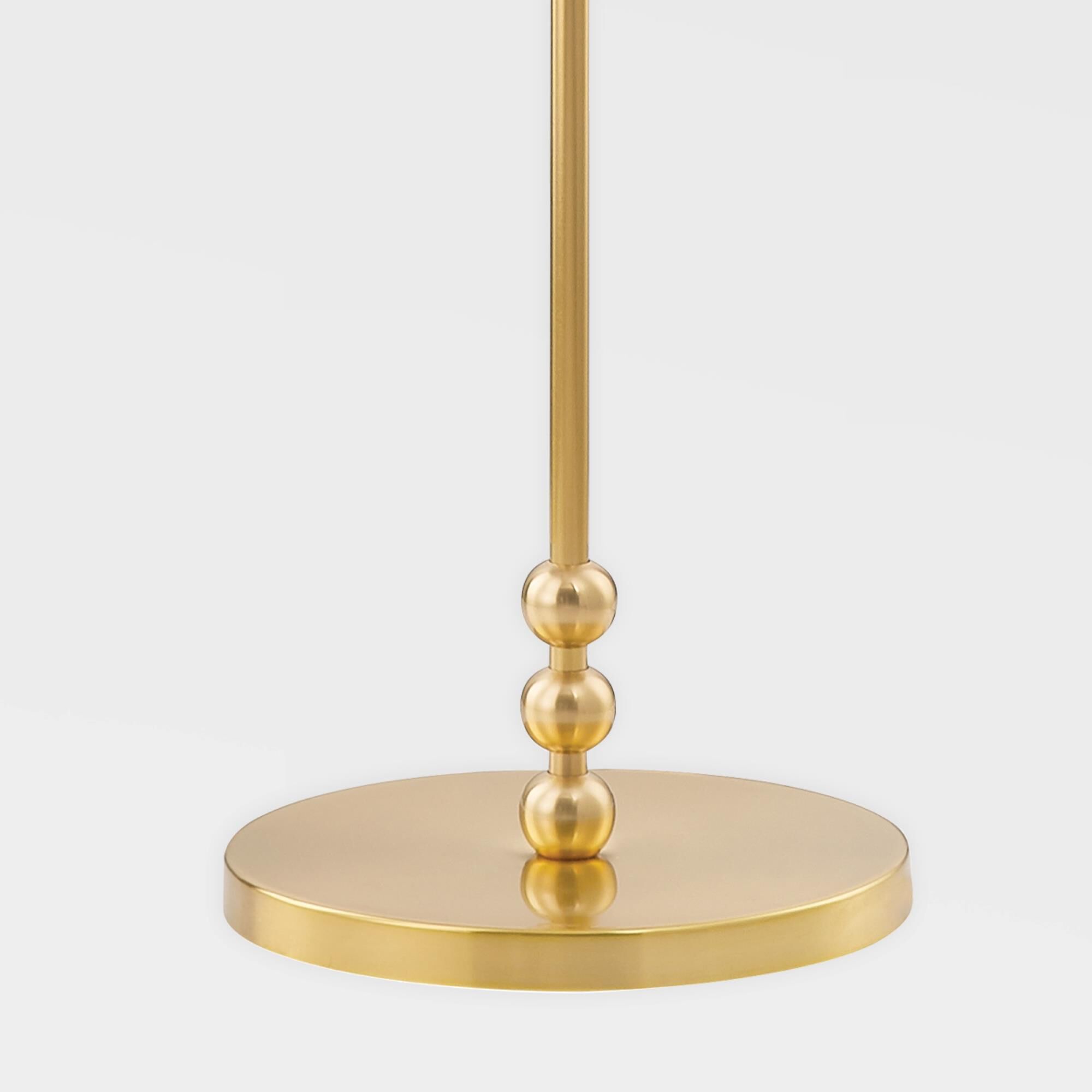 Shown in Aged Brass finish and White Linen shade