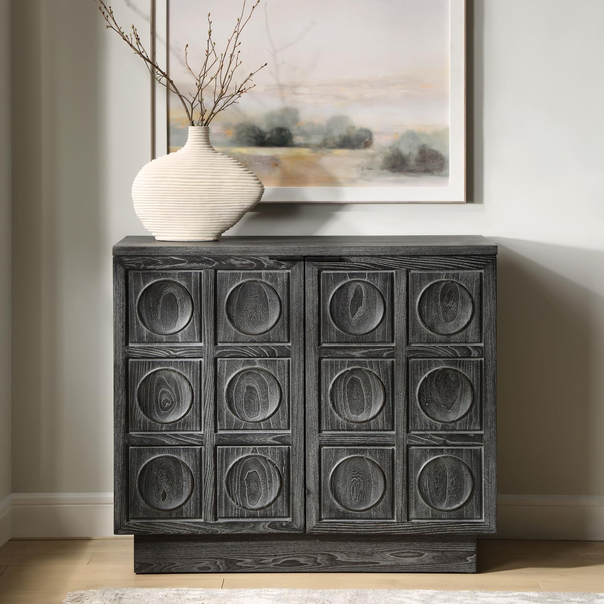 Shown in A Two Door Cabinet Featuring A Striking Carved Circular Design, Constructed From Solid Elm And Elm V finish