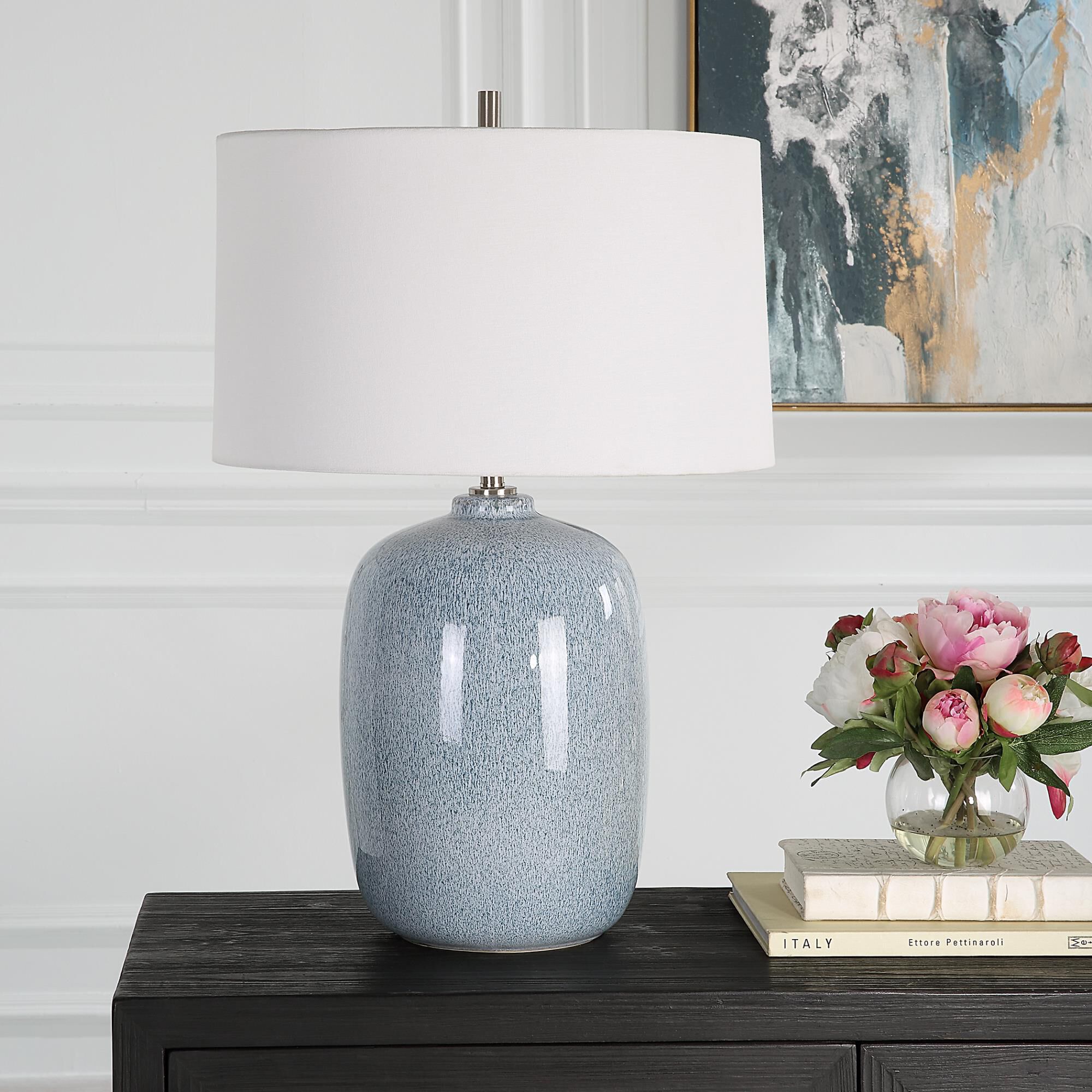 Shown in This Ceramic Table Lamp Features A Peaceful Sky Blue Glaze With Cobalt Mottled Details Paired With P finish and Round Hardback shade