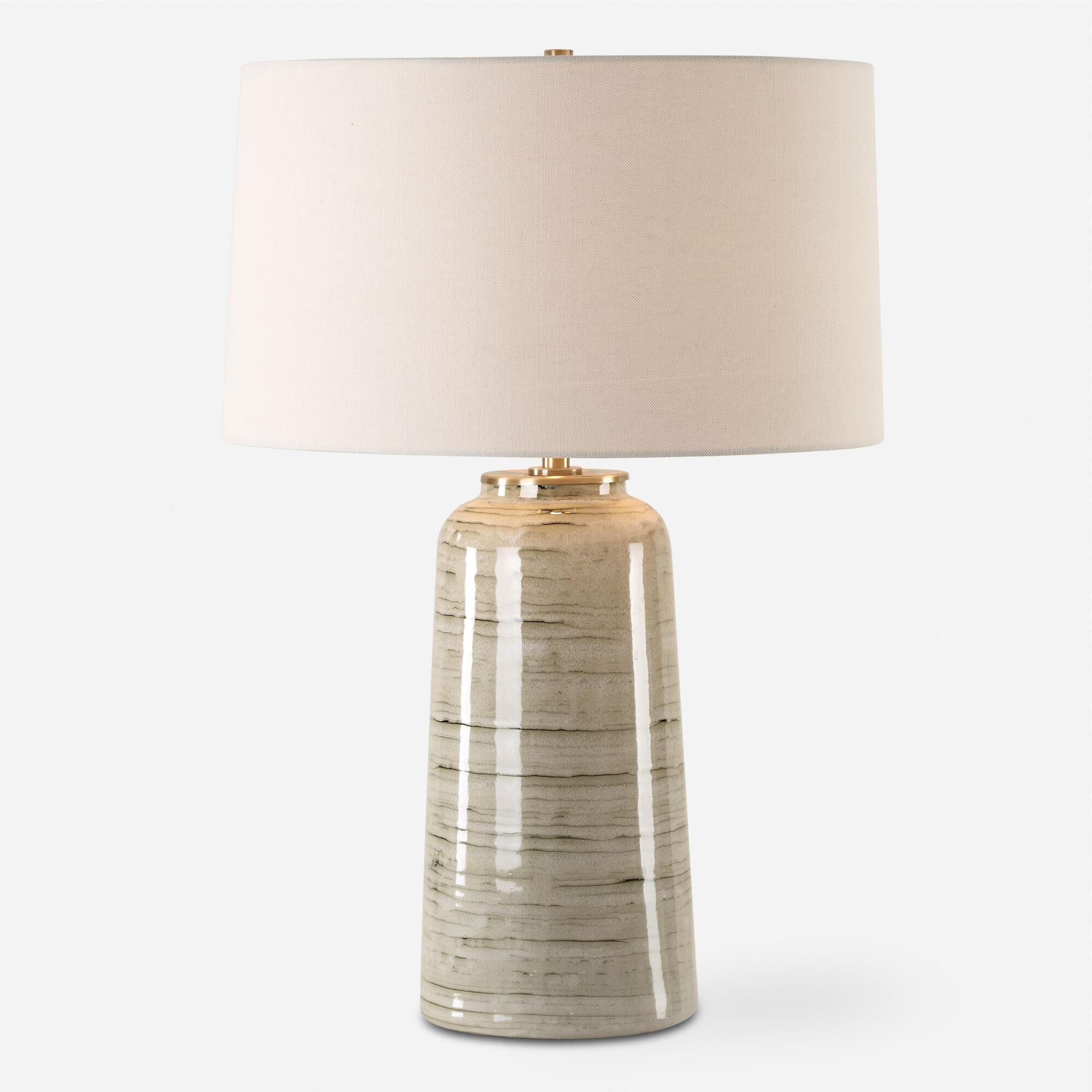 Shown in This Ceramic Table Lamp Features A Greenish Tan Glaze With Dark Undertones, Accented With Plated Ant finish and Round Hardback shade