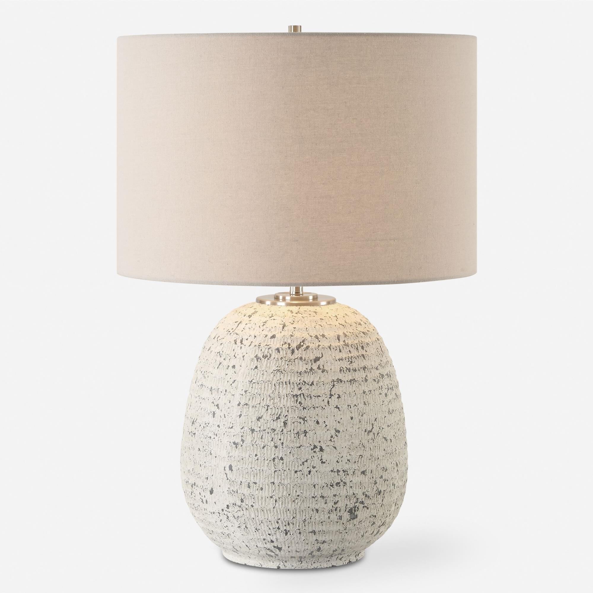 Shown in This Ceramic Table Lamp Boast A Ribbed Textured Surface Finished In A Heavily Distressed Stone Ivory finish and Round Drum Hardback shade