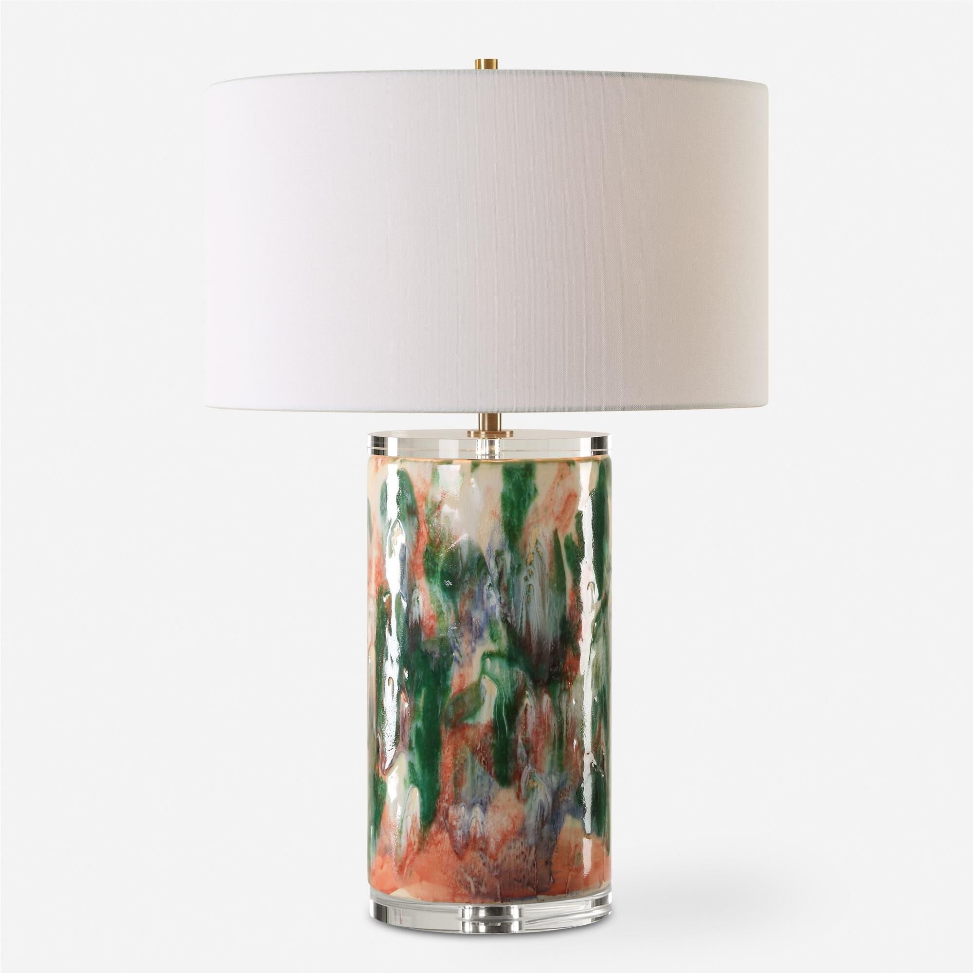 Shown in This Unique Ceramic Lamp Is Finished Like An Abstract Piece Of Art Featuring Shades Of Luscious Gree finish and Round Drum Hardback shade