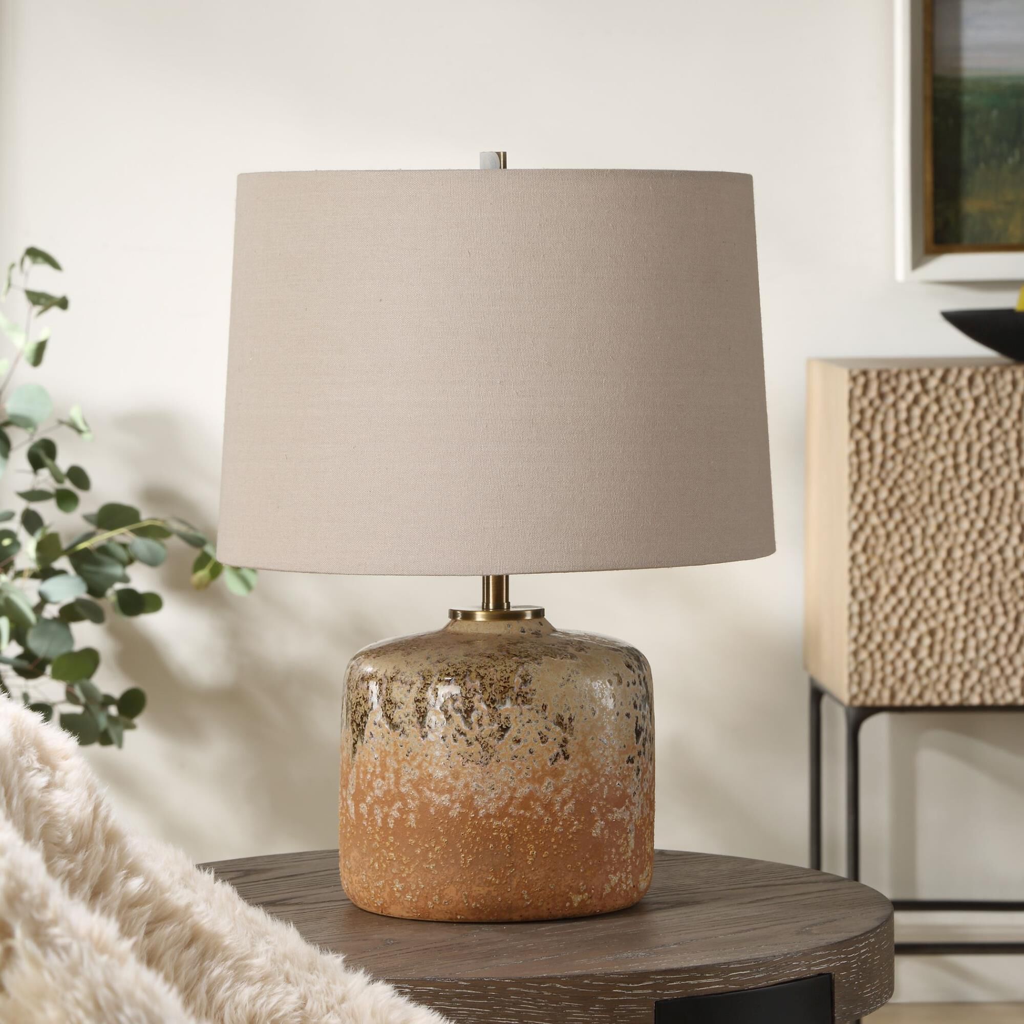 Shown in Bringing The Rustic Charm Of The West Indoors, The Canyon Table Lamp Features A Chocolate And Tan Mo finish and Round Hardback shade