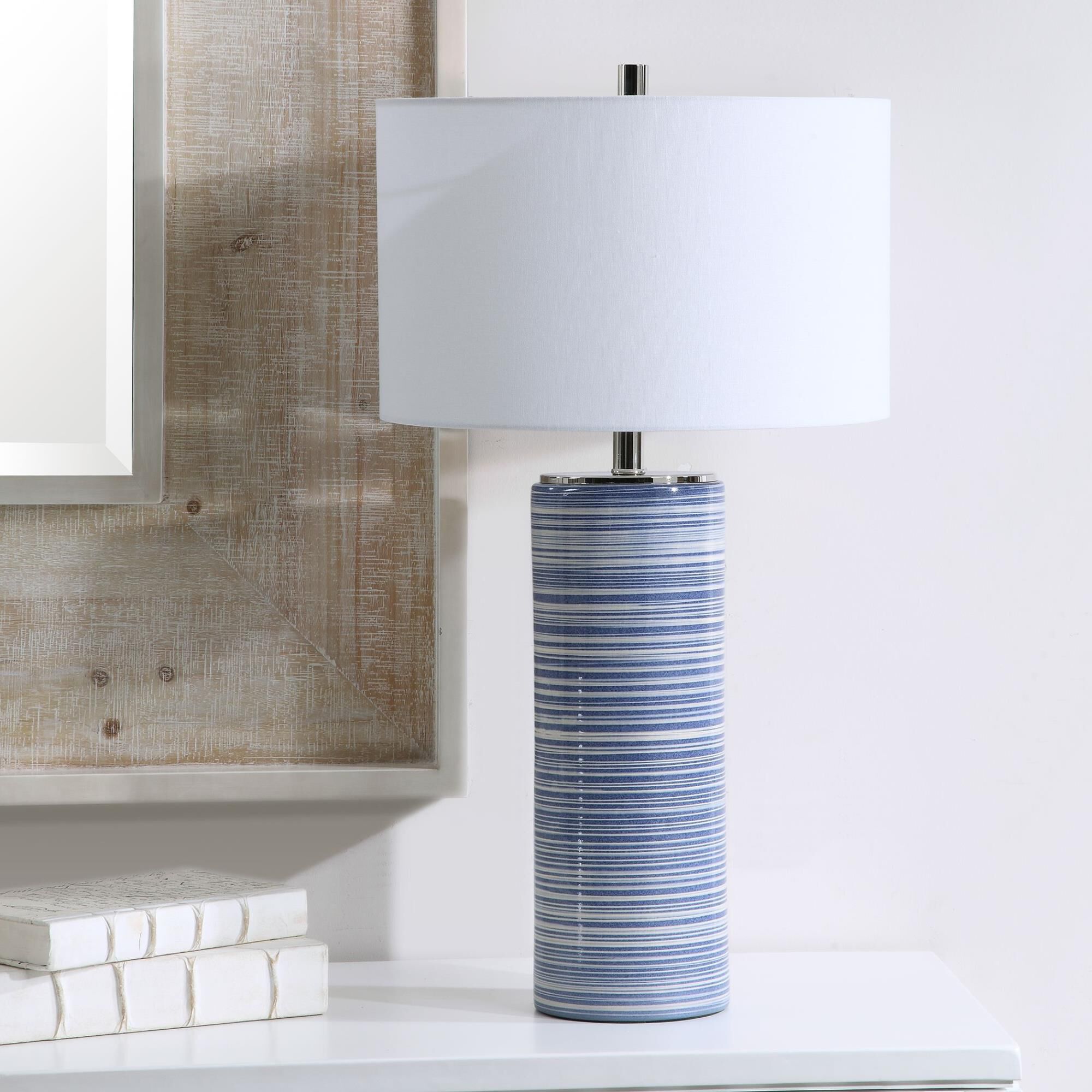 Shown in Showcasing Trendy White And Indigo Hues, This Ceramic Table Lamp Has A Striped Glaze With Polished N finish and Round Drum Hardback shade