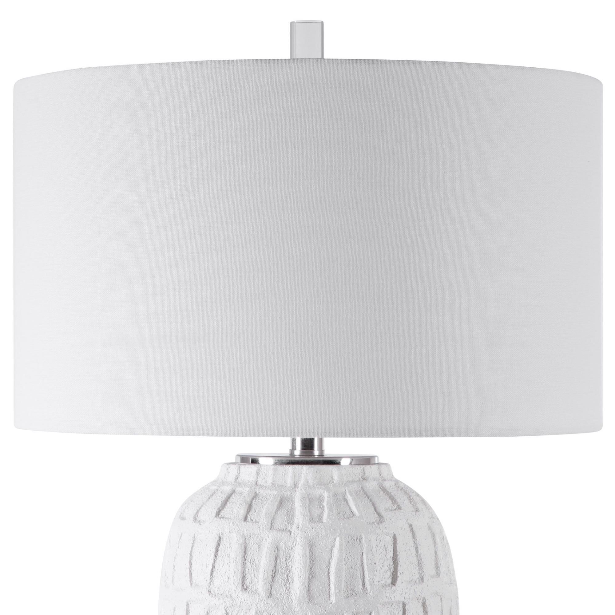 Shown in A Modern Take On Old World Style, This Table Lamp Features A Textured, Matte White Ceramic Base With finish and Drum Hardback  Rolled Edge shade