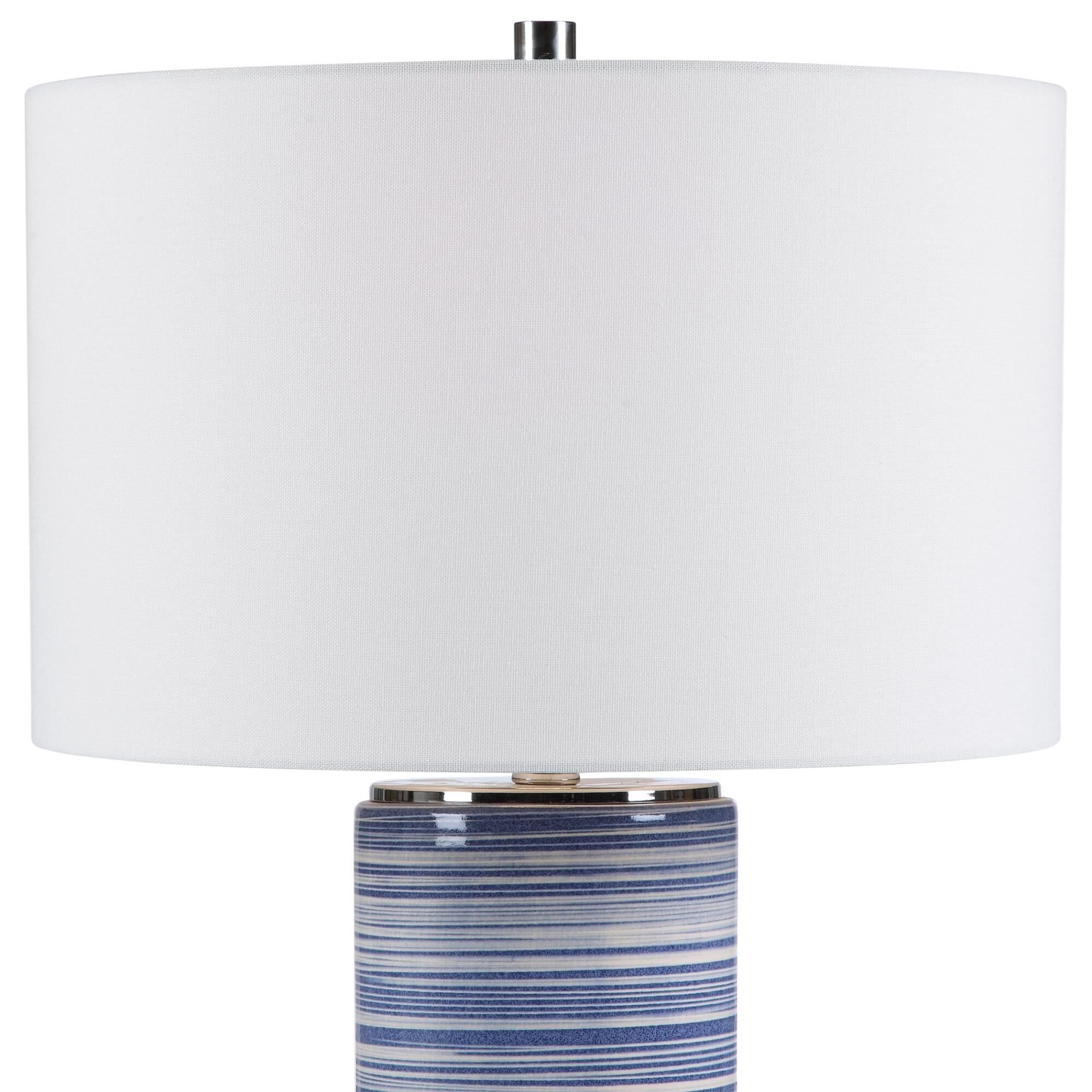 Shown in Showcasing Trendy White And Indigo Hues, This Ceramic Table Lamp Has A Striped Glaze With Polished N finish and Round Drum Hardback shade