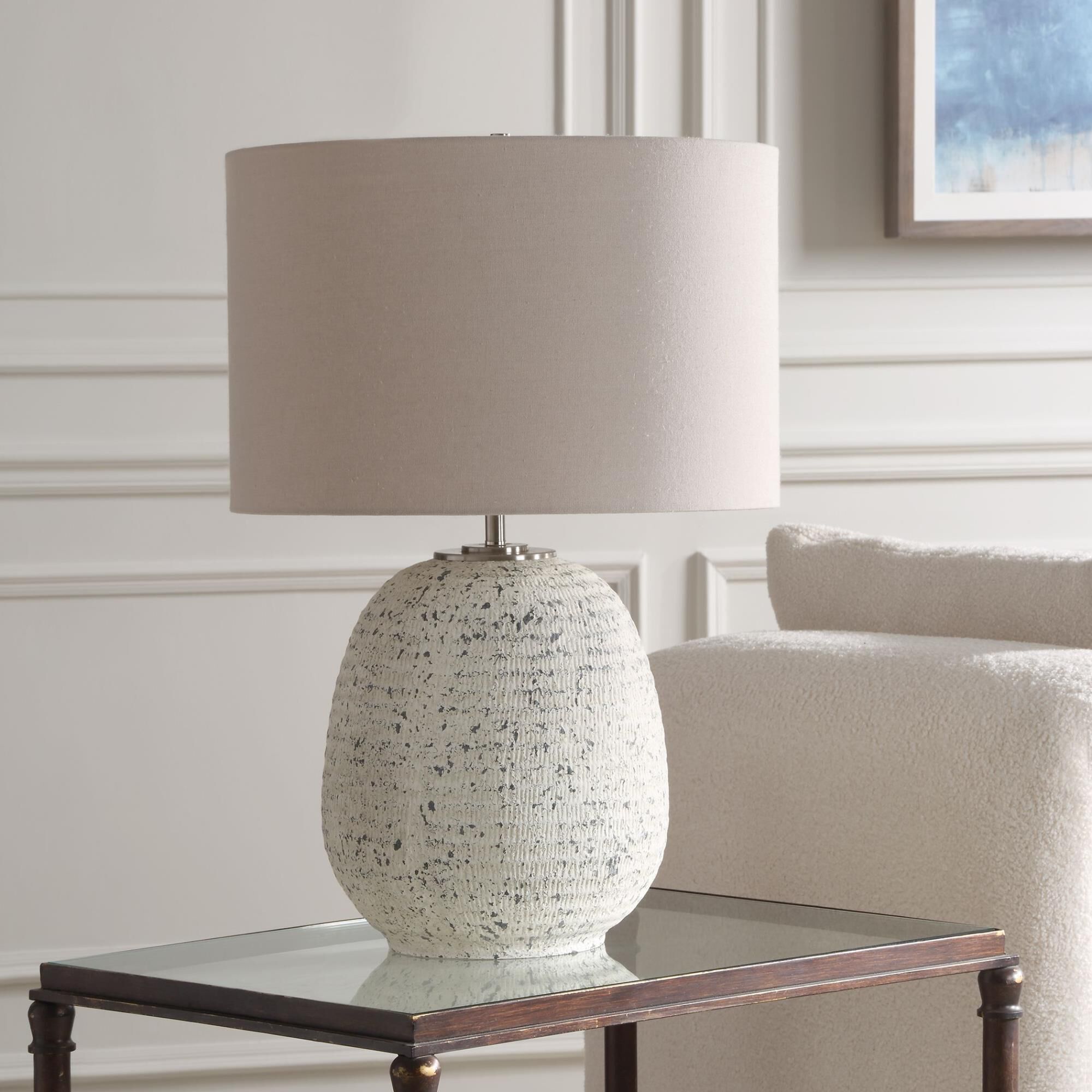 Shown in This Ceramic Table Lamp Boast A Ribbed Textured Surface Finished In A Heavily Distressed Stone Ivory finish and Round Drum Hardback shade