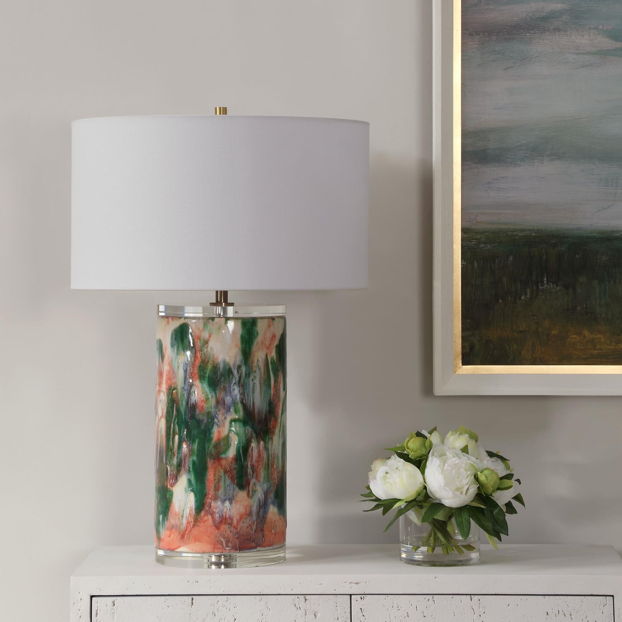 Shown in This Unique Ceramic Lamp Is Finished Like An Abstract Piece Of Art Featuring Shades Of Luscious Gree finish and Round Drum Hardback shade