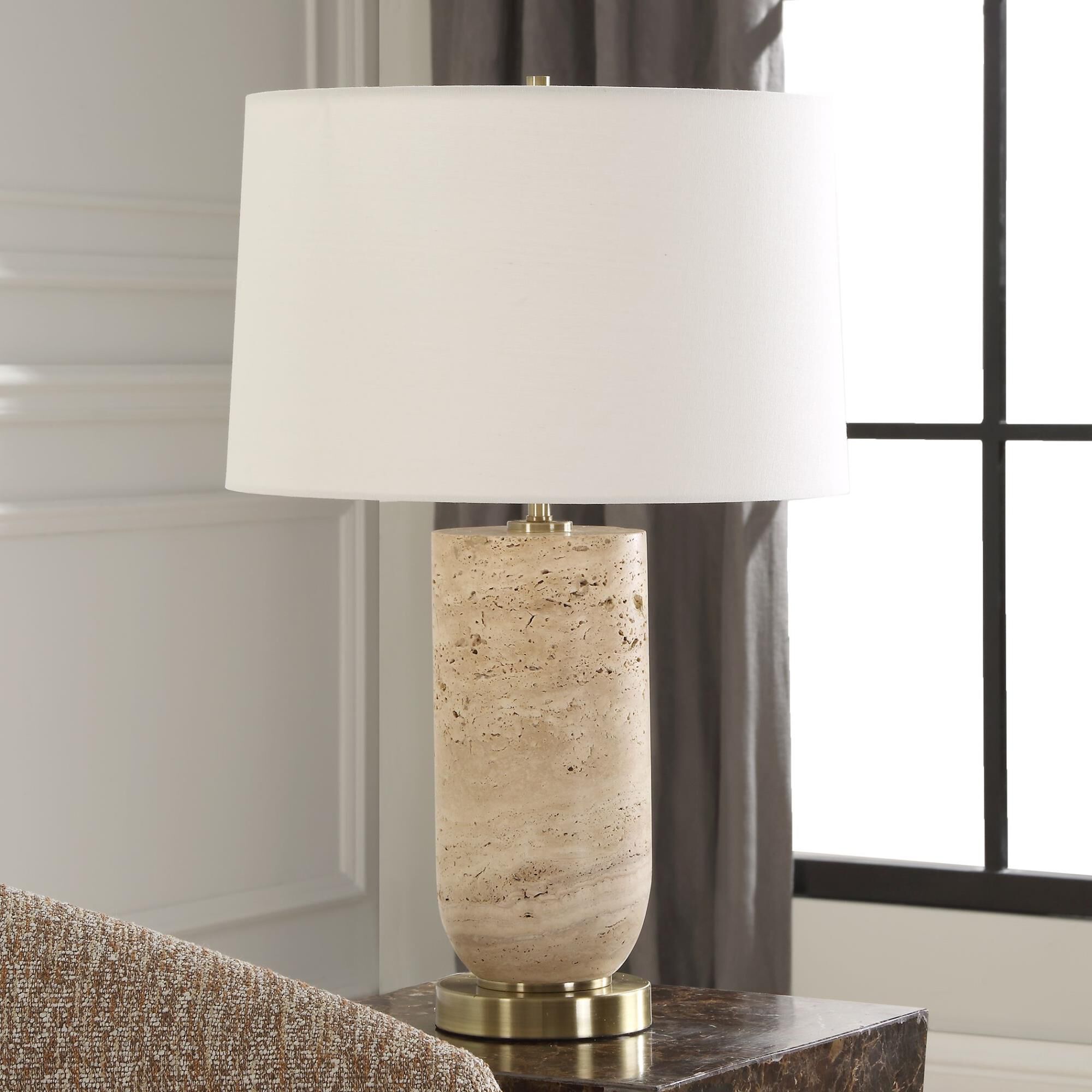 Shown in The Aubrey Table Lamp Harmonizes Natural Beauty With Classic Elegance. Crafted From Travertine, Its  finish and Round Hardback shade