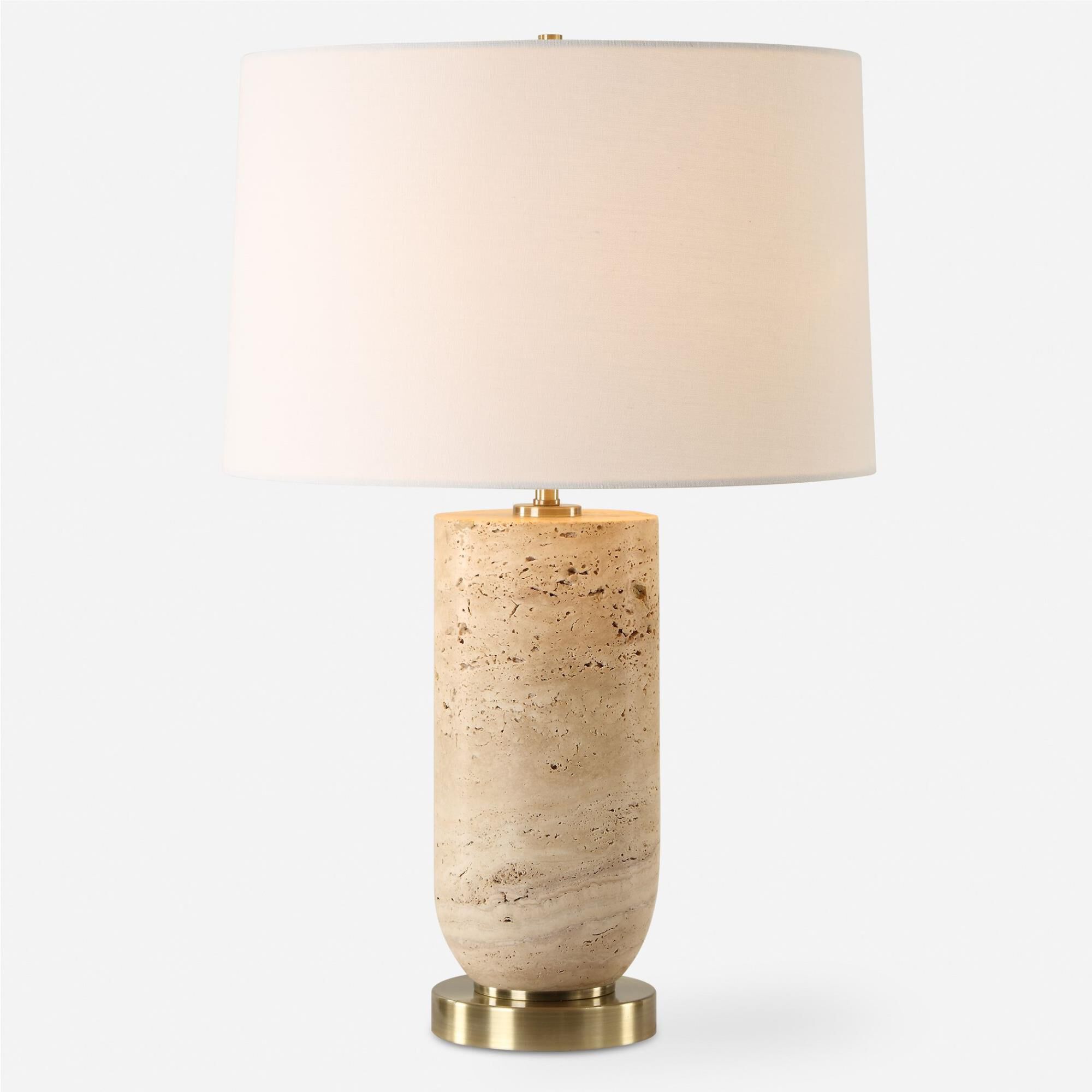 Shown in The Aubrey Table Lamp Harmonizes Natural Beauty With Classic Elegance. Crafted From Travertine, Its  finish and Round Hardback shade