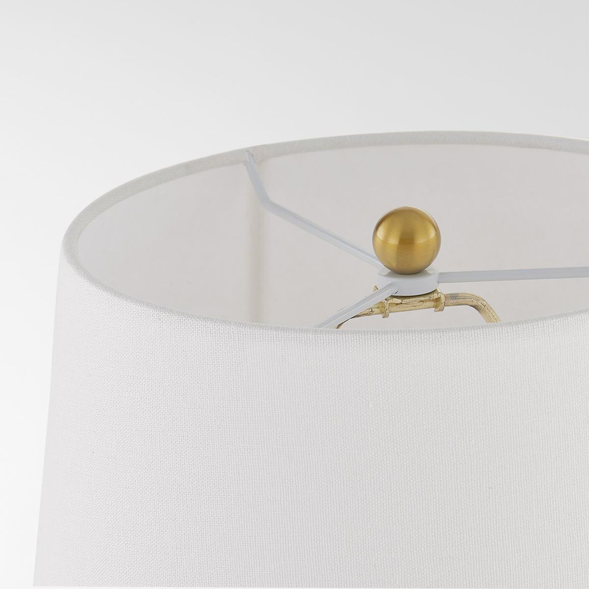 Shown in Aged Brass finish and White Linen shade