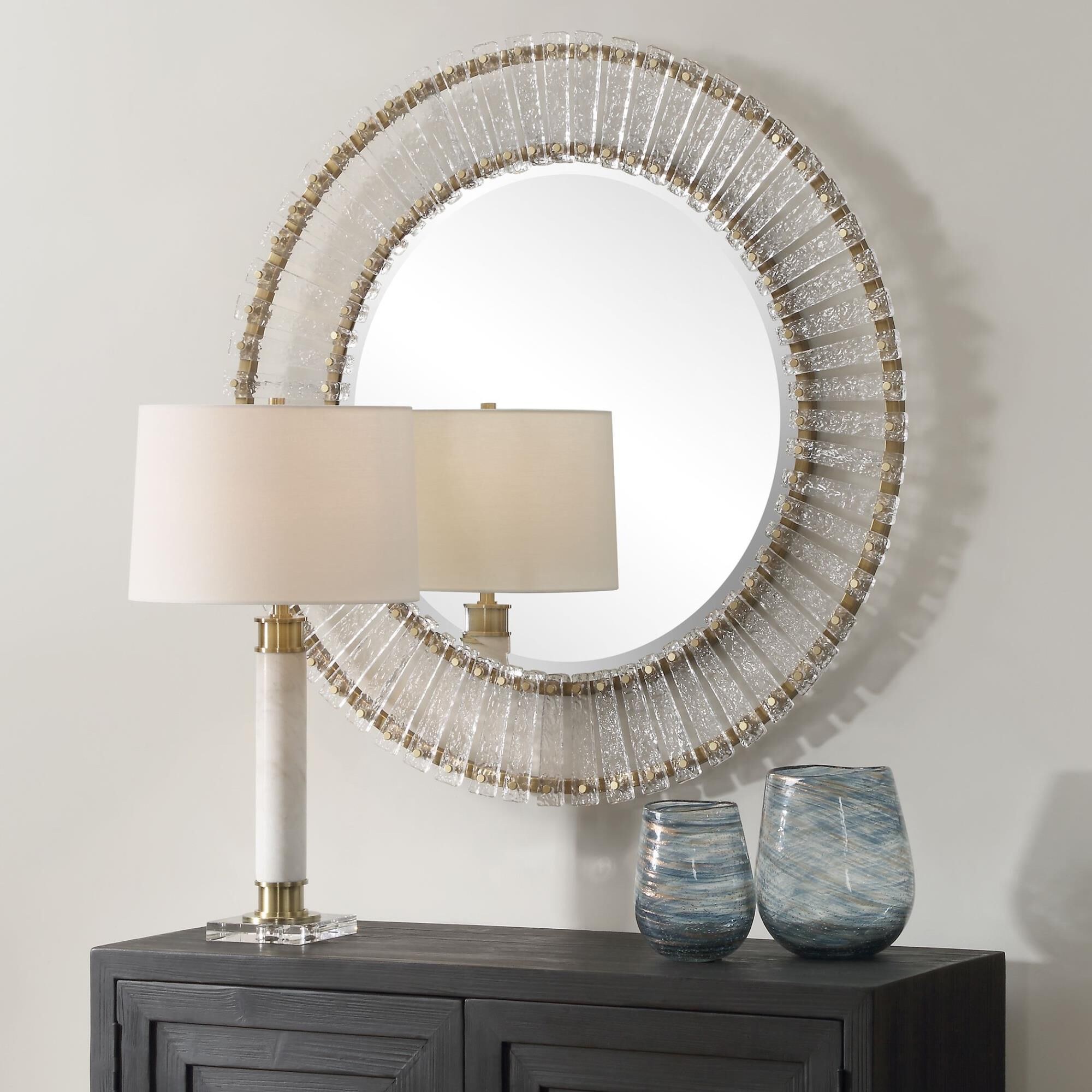 Shown in The Denali Round Mirror Features Textured Glass Keys Suspended Around Brushed Gold  Iron Frames. Mir finish