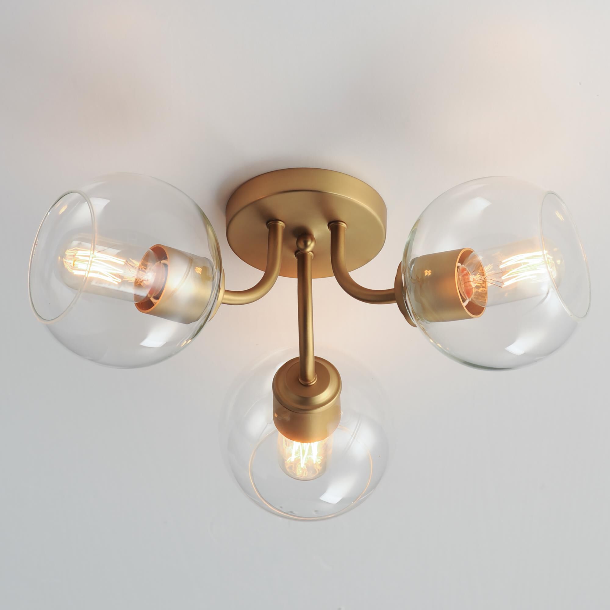 Shown in Natural Aged Brass finish and Clear glass and Glass shade