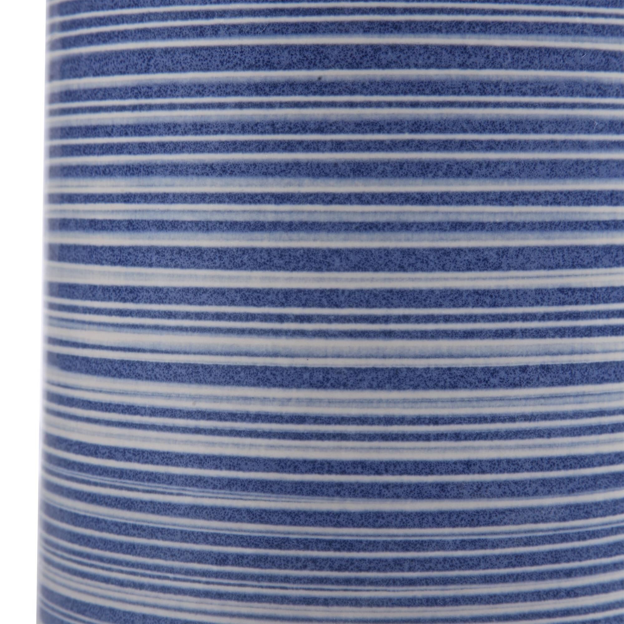 Shown in Showcasing Trendy White And Indigo Hues, This Ceramic Table Lamp Has A Striped Glaze With Polished N finish and Round Drum Hardback shade