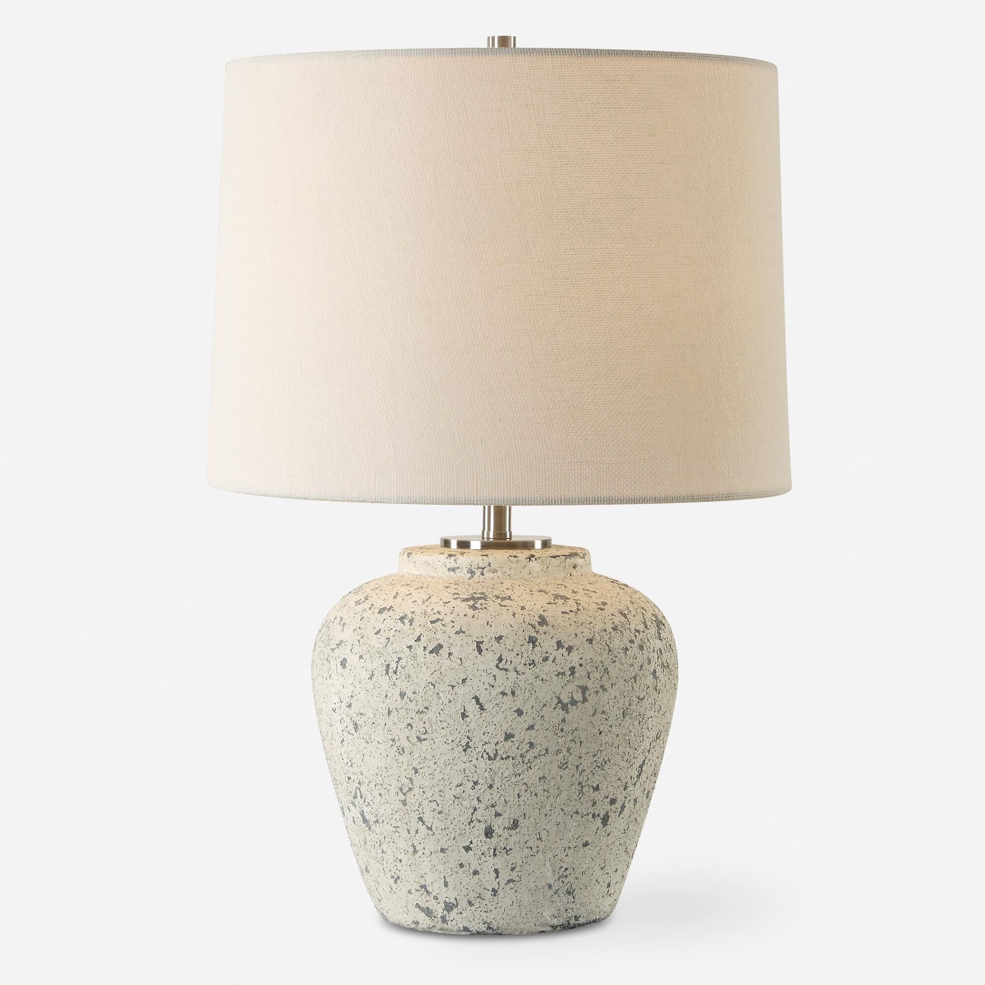 Shown in The Rupture Table Lamp Features A Heavily Distressed Aged Ivory Finish With Stone Gray Undertones An finish and Round Hardback shade