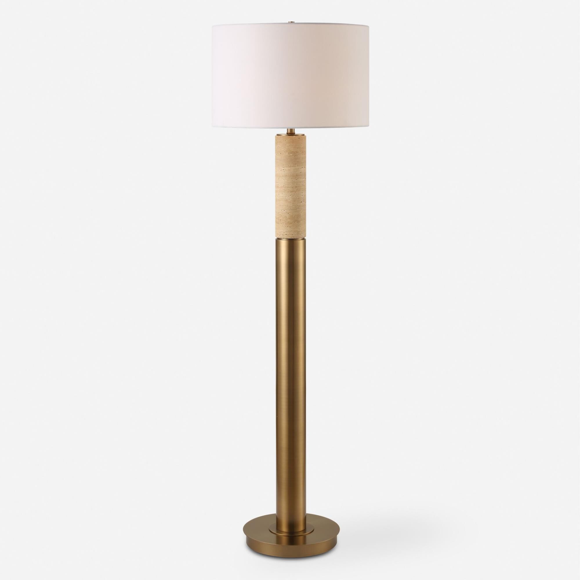 Shown in The Knox Floor Lamp Showcases A Solid Travertine Column Displayed On A Matching Antique Brass Plated finish and Round Hardback shade